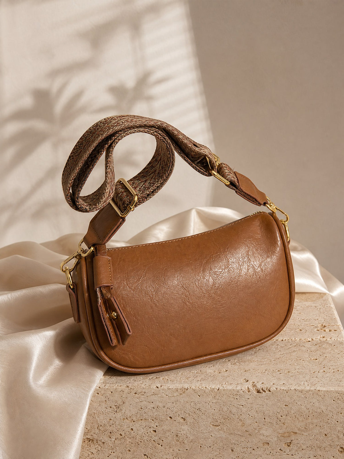 Odette Slouch Baguette, styled on travertine