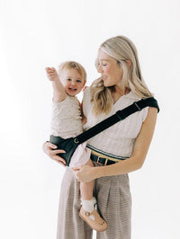 Toddler seated on the hip with legs in the M-position