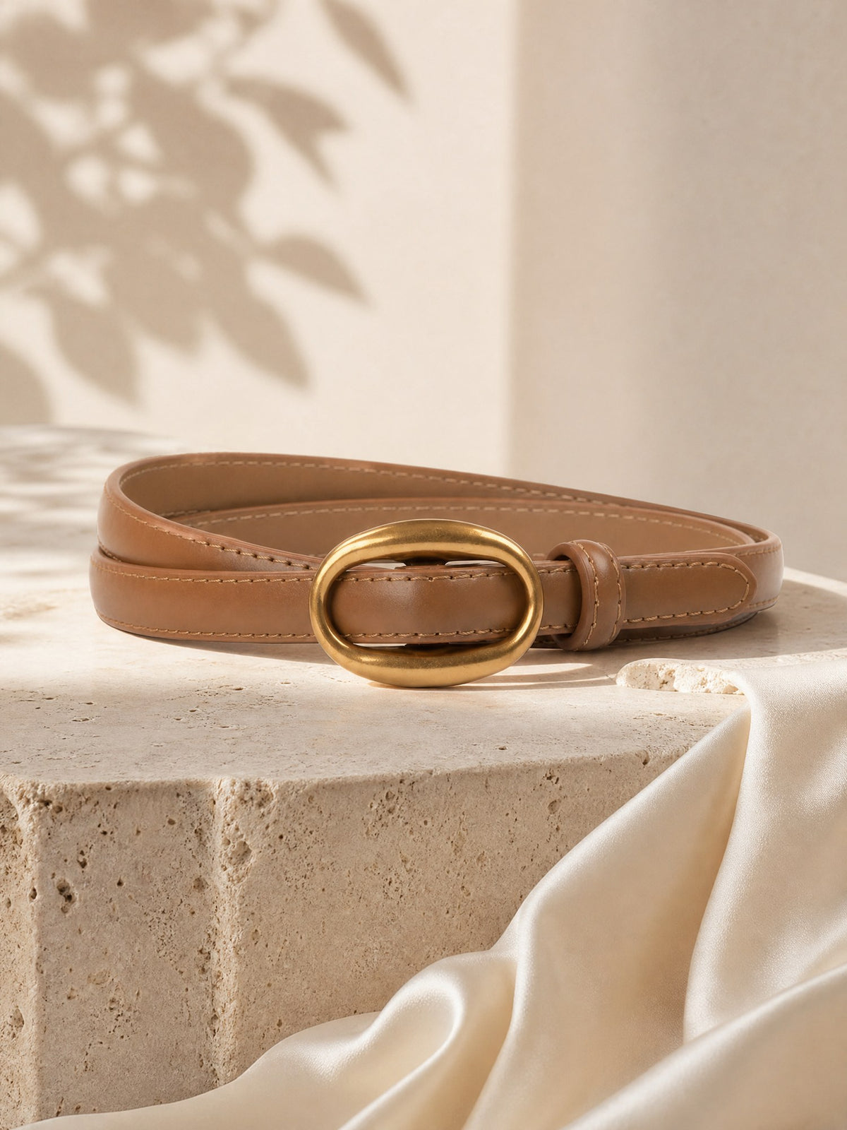 Ovale Gold-Buckle Belt, styled on travertine