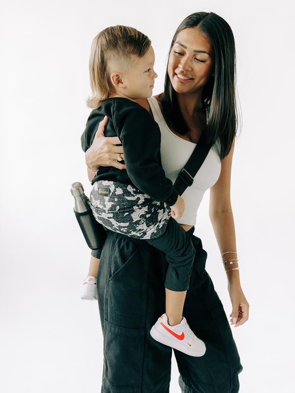 Carrying a toddler in the camo LiftOff sling with the bottle sleeve in use