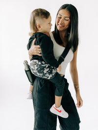 Carrying a toddler in the camo LiftOff sling with the bottle sleeve in use