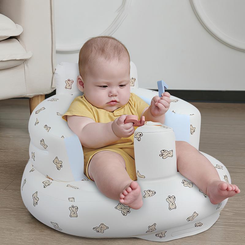 Baby sitting in the seat at home, playing