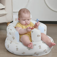 Baby sitting in the seat at home, playing