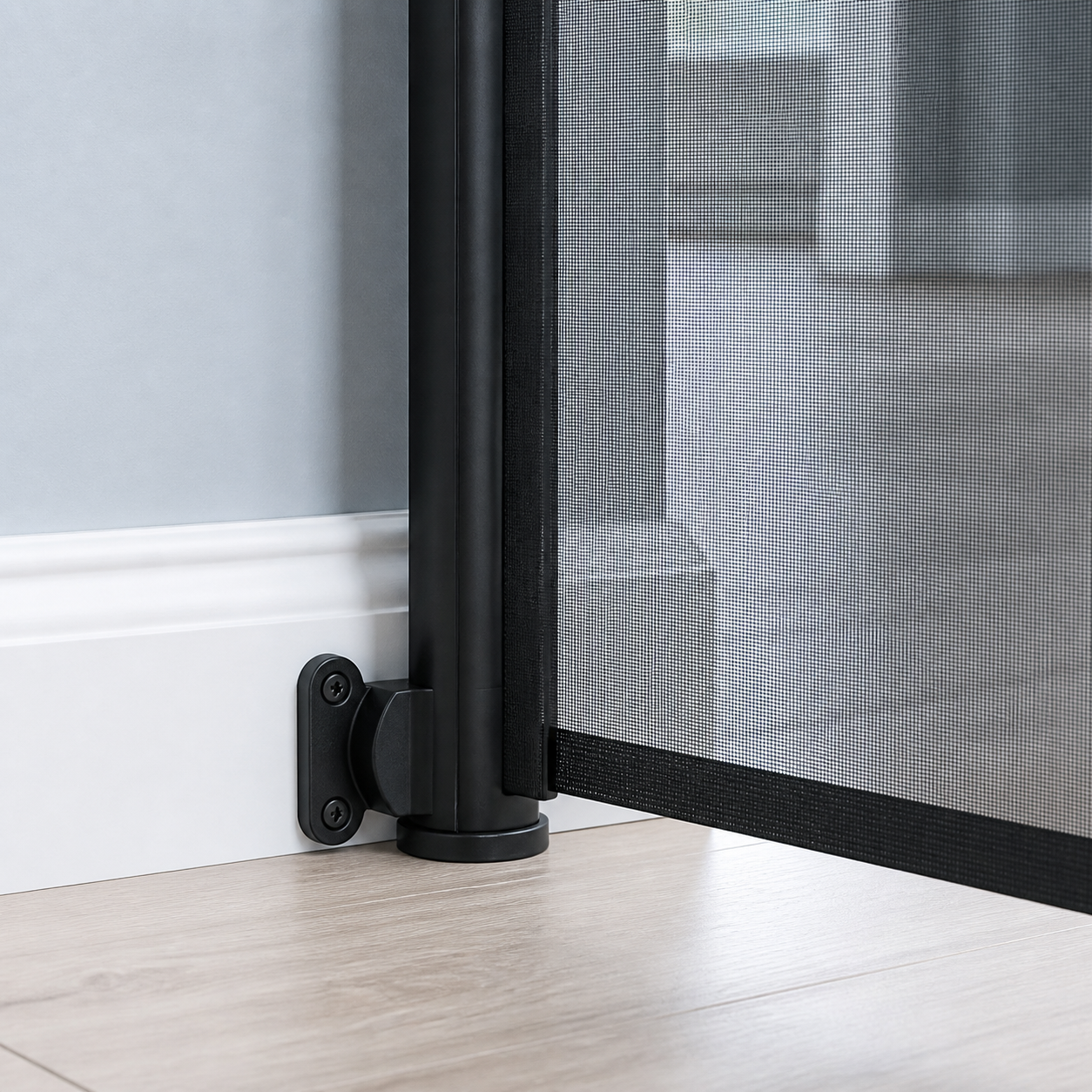 Close view of the retractable pet gate wall mount aligned over a baseboard