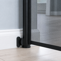 Close view of the retractable pet gate wall mount aligned over a baseboard