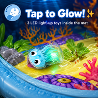 Close-up of a glowing LED sea creature sealed inside the mat — three light-up toys included