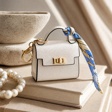White mini bag keychain, twist-lock clasp and silk ribbon detail