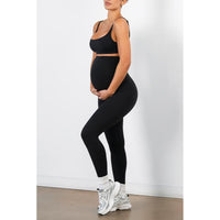 Full side view of the leggings worn over the bump