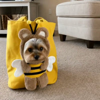 Yorkshire terrier sitting inside the yellow bee carrier tote at home View 2