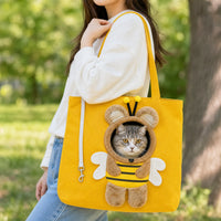 Woman carrying the yellow bee carrier tote on her shoulder with a cat looking out View 5