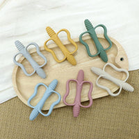 Teethers on a wooden board, showing the textured outer edge
